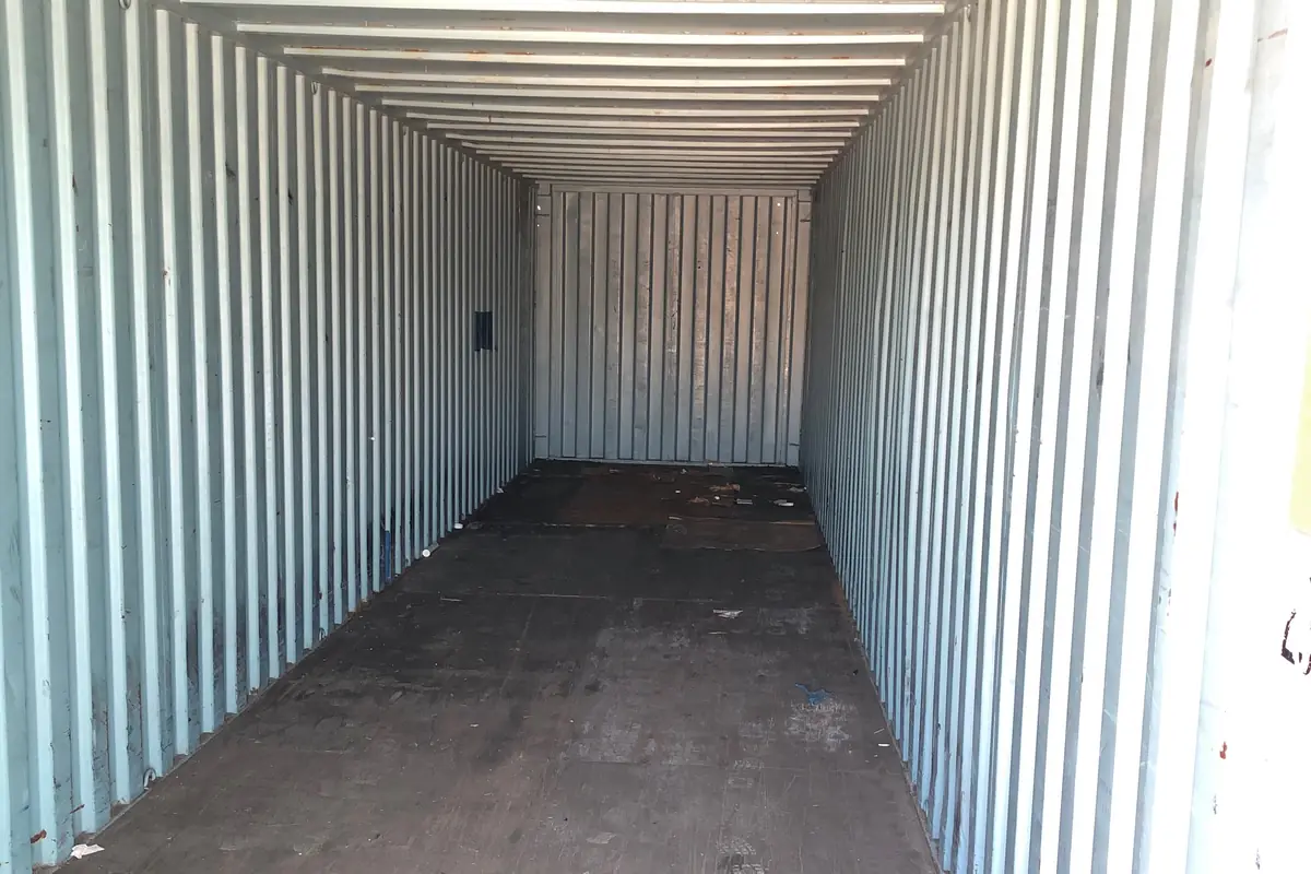 Inside an empty used storage container looking towards the far end