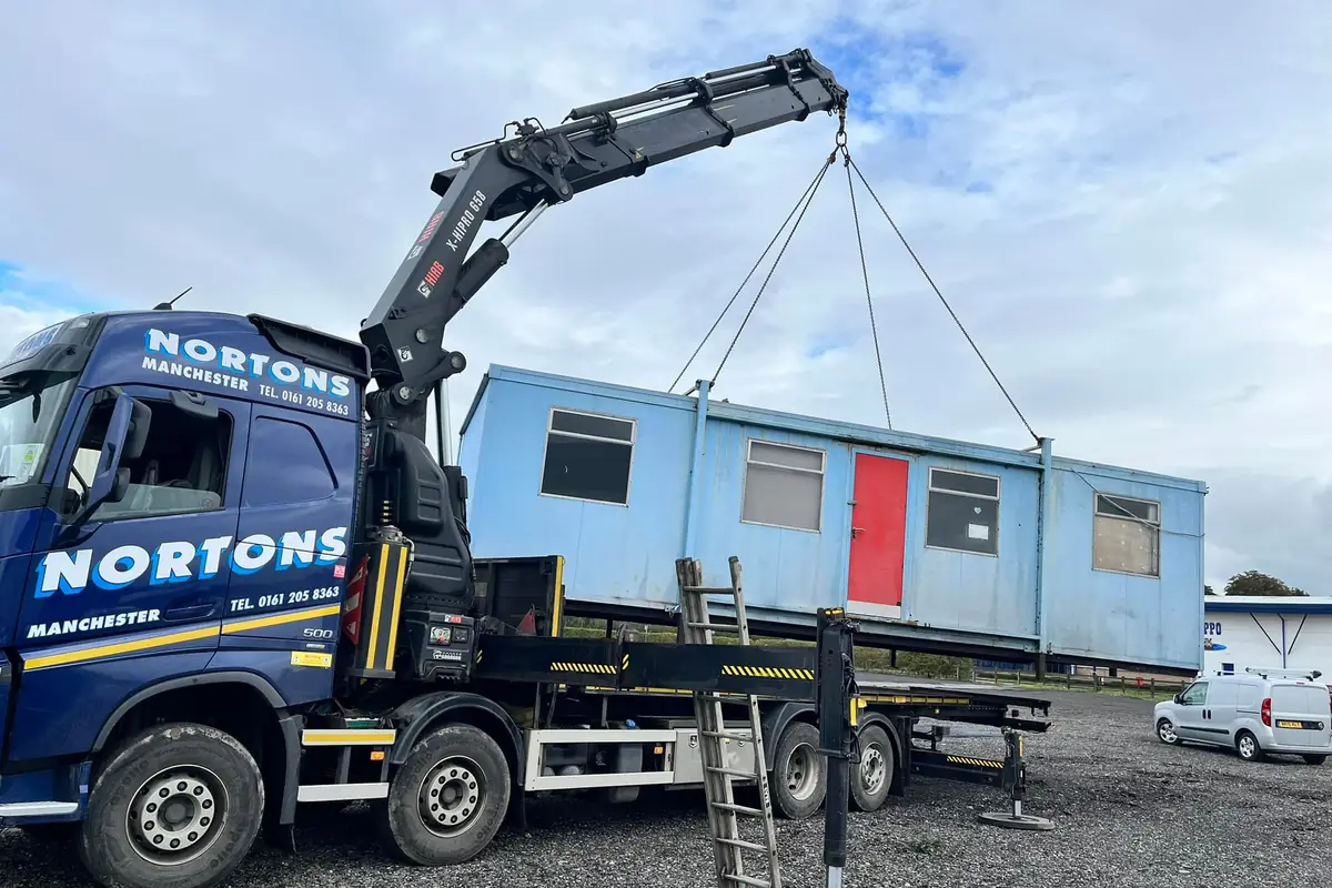 Modular building section lifted off its base during a site clearance