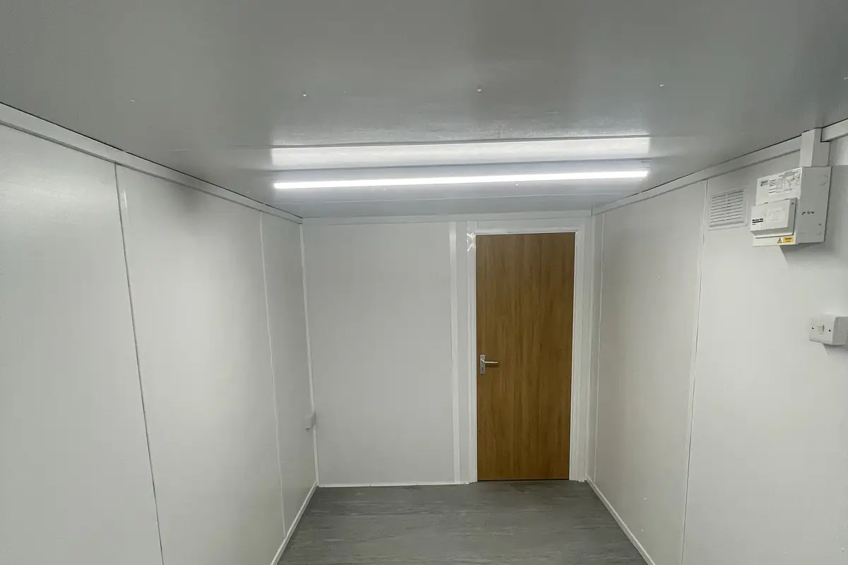 Refurbished interior of a used modular building with new flooring and lighting