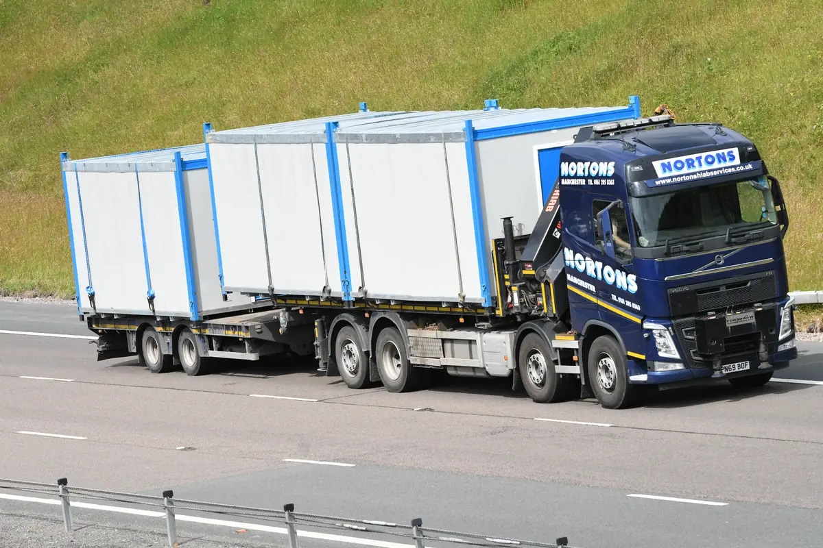 Modular building section on a lorry travelling on a motorway