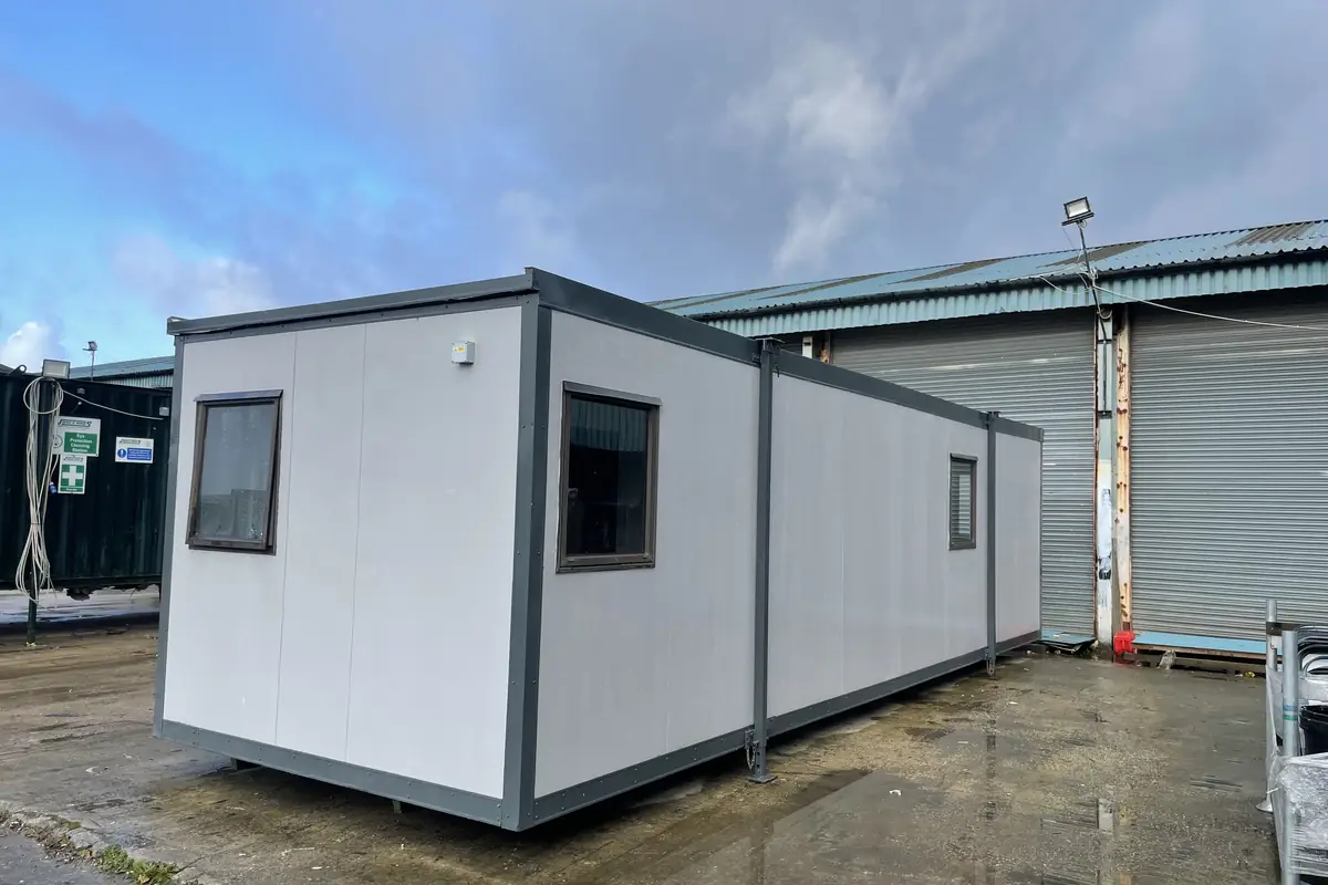 Row of used portable buildings standing in a yard ready for sale
