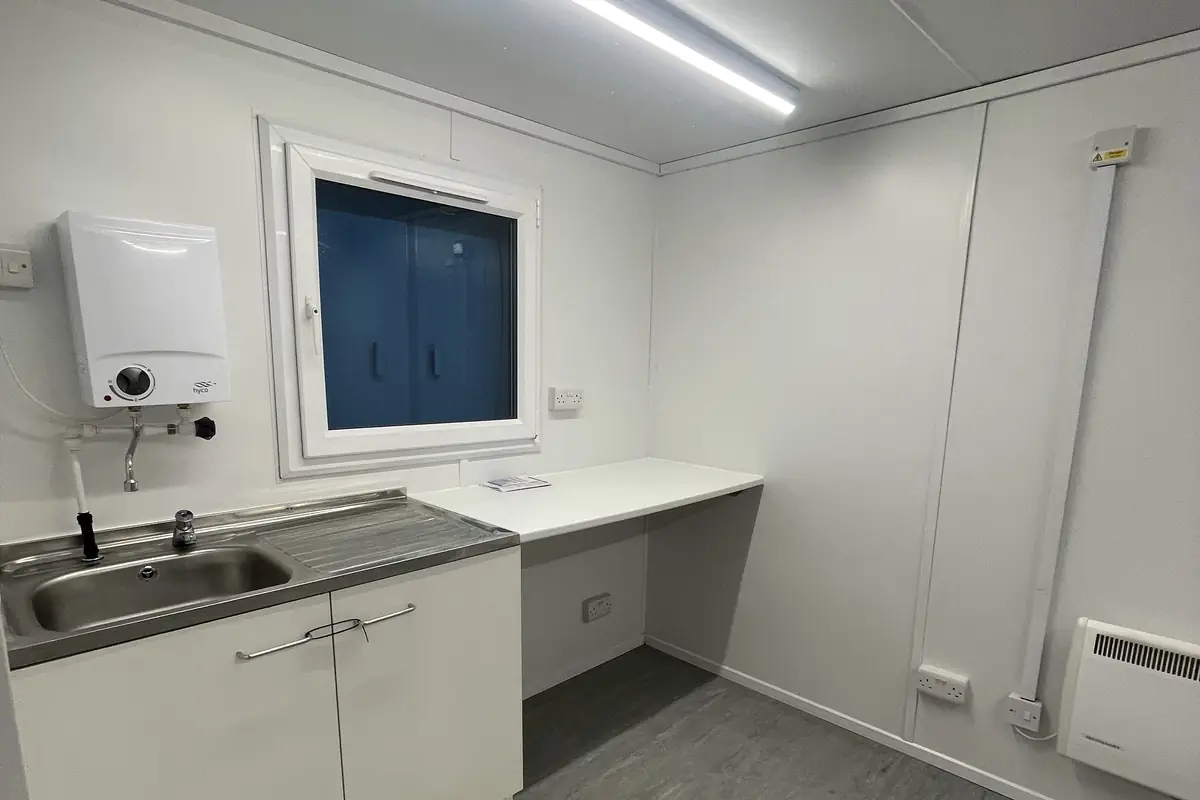 Interior of a refurbished portable office with new flooring and lighting