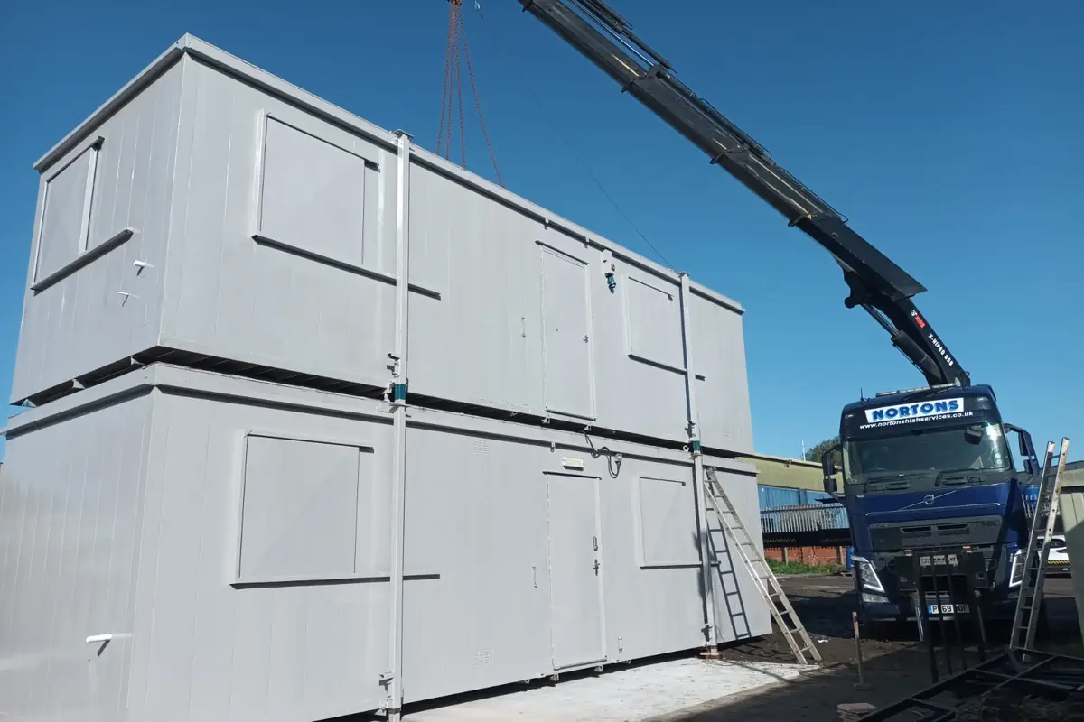 Two-storey temporary building being lifted into position as extra accommodation